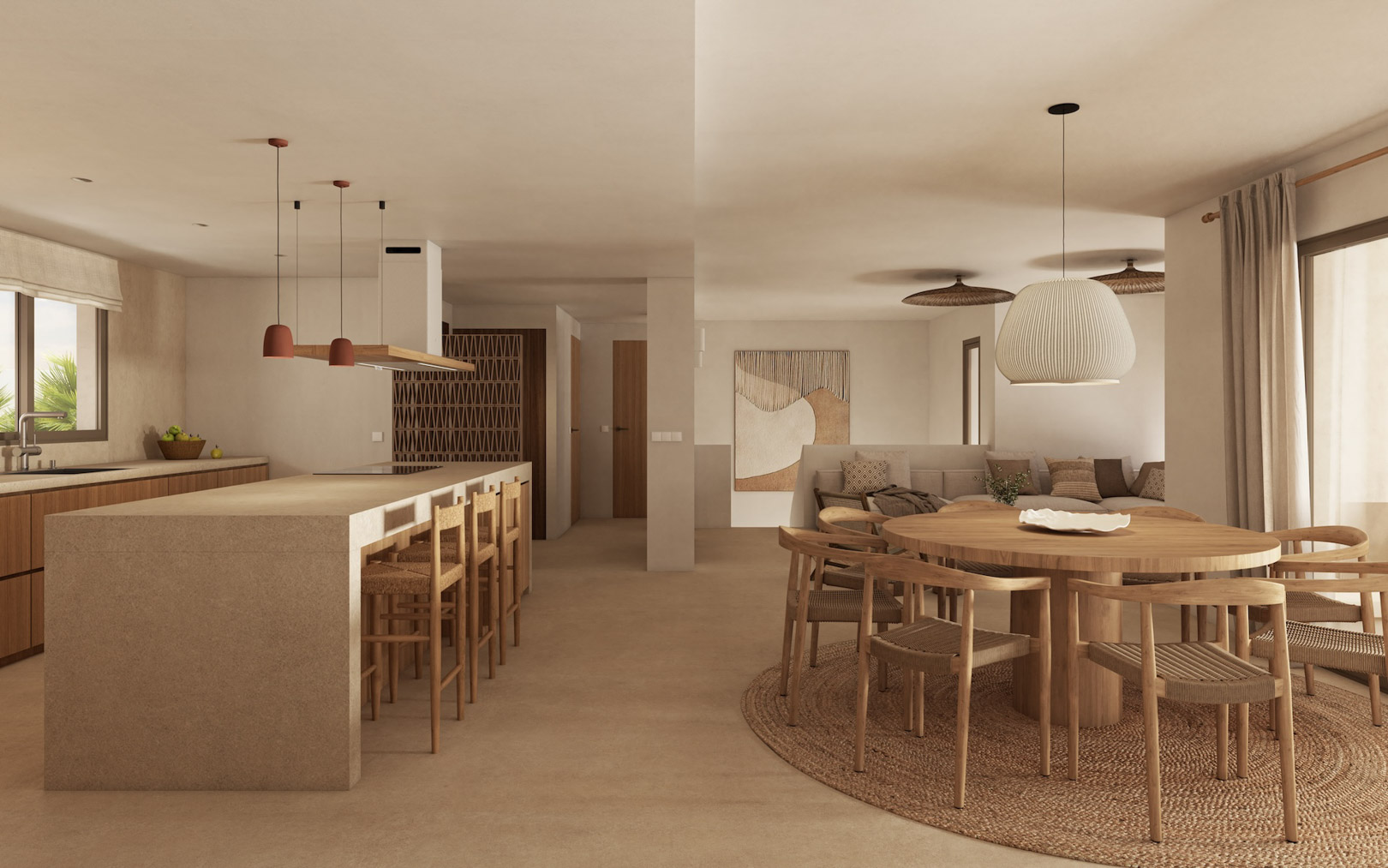 Espacio diáfano que integra una cocina con isla de piedra y taburetes de madera, junto a un comedor con mesa circular y lámparas de diseño en tonos tierra.