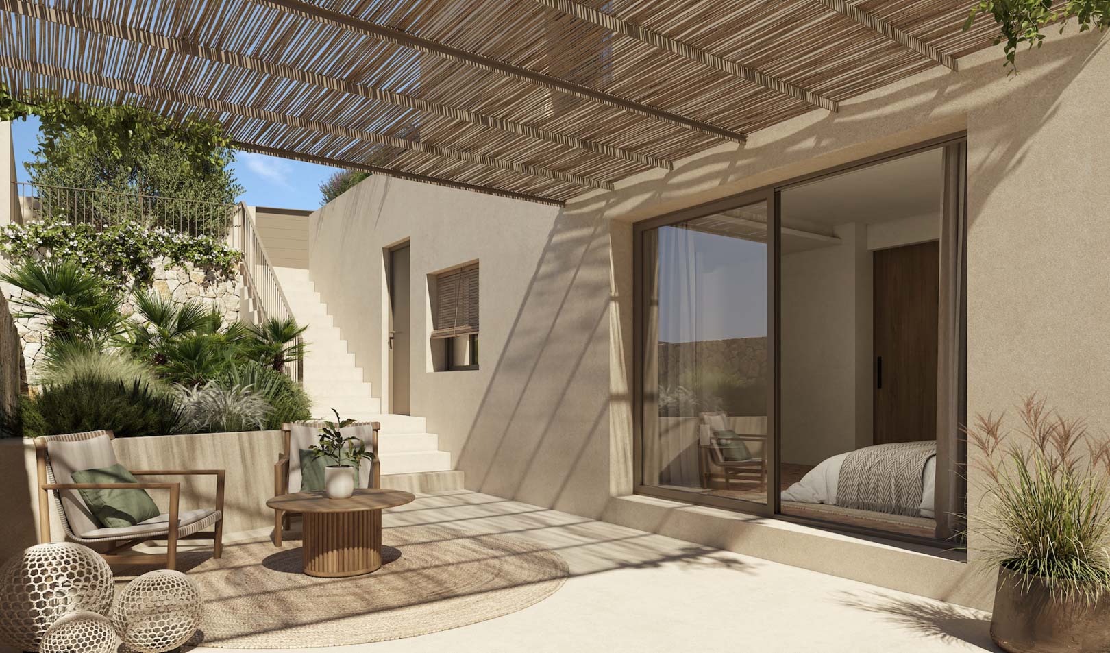 Terraza exterior con pérgola de cañizo, zona de estar con mobiliario de madera y acceso directo al dormitorio a través de grandes ventanales correderos.