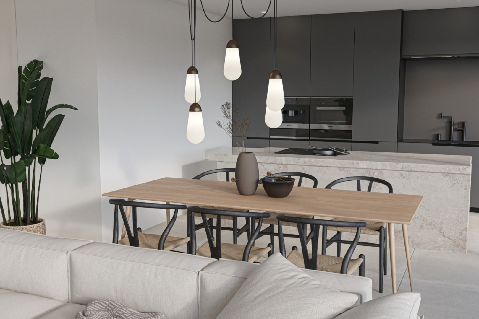 Comedor y cocina de diseño con isla de piedra natural, armarios en gris antracita, electrodomésticos integrados y lámparas colgantes sobre una mesa de madera clara.