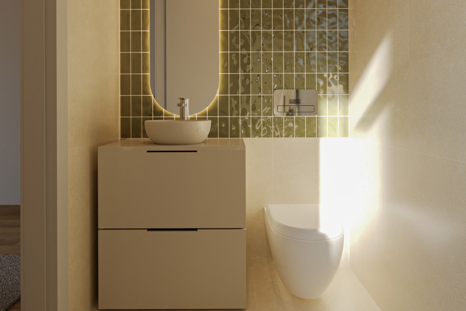 Aseo de invitados con lavabo sobre encimera, mueble de dos cajones y espejo ovalado retroiluminado sobre azulejos verdes texturizados.