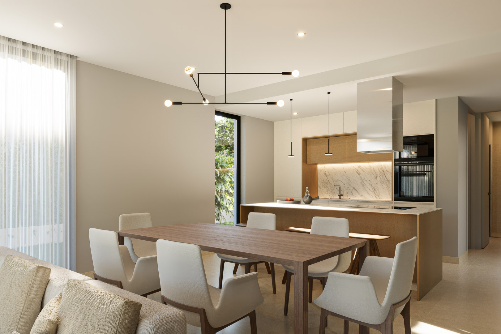 Salón-comedor integrado con cocina de diseño, destacando la isla con encimera de mármol, mobiliario de madera y una moderna lámpara geométrica sobre la mesa principal.