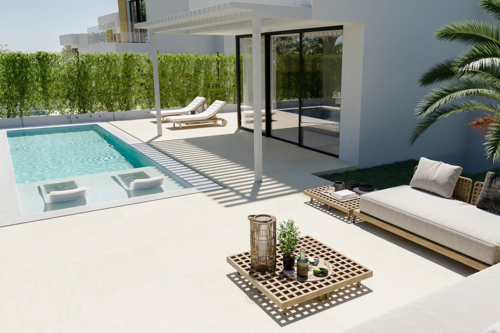 Terraza exterior con piscina privada, tumbonas sumergidas y zona de estar con mobiliario de diseño bajo una pérgola de lamas.