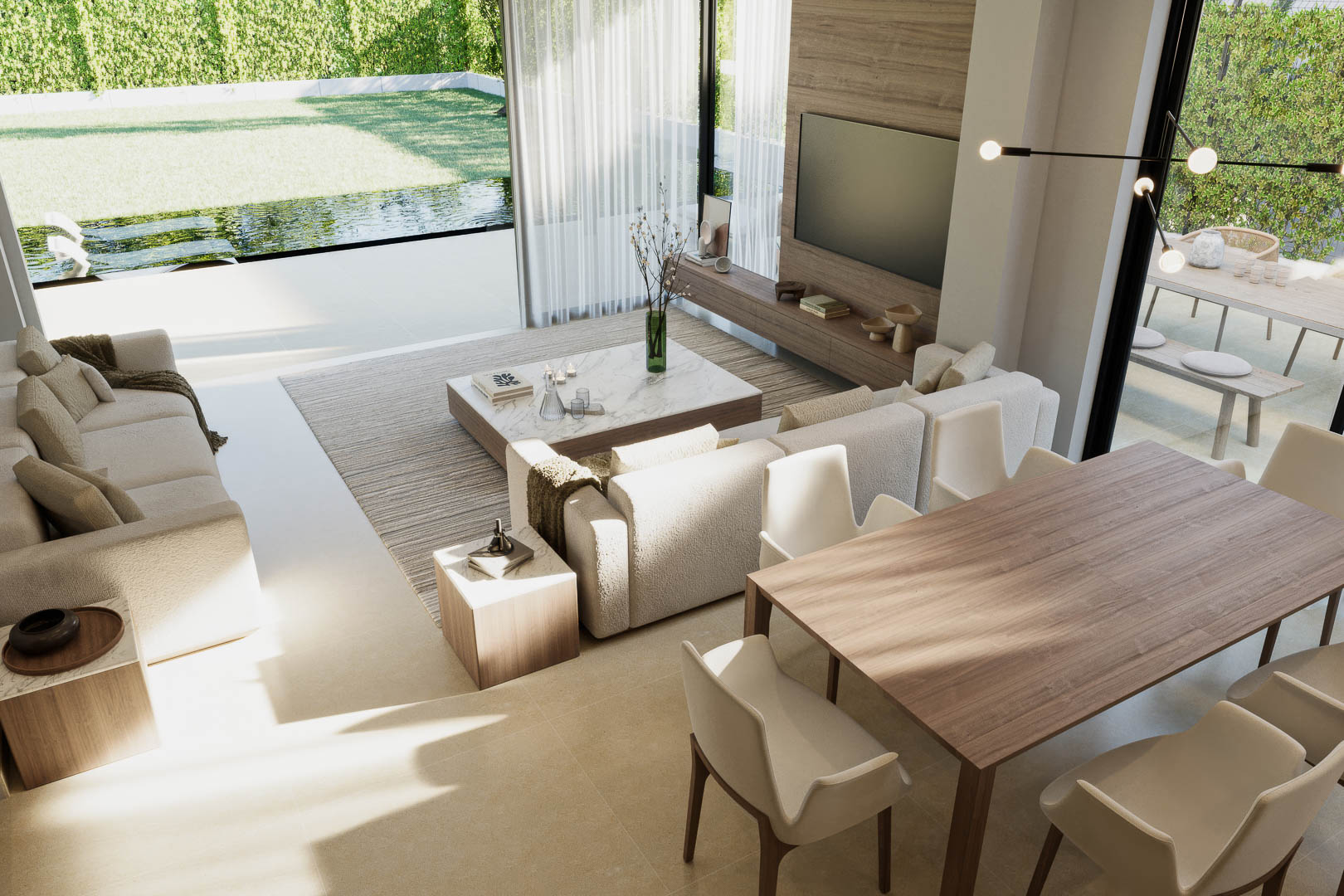 Vista del salón-comedor con sofás tapizados, mesa de comedor de madera y acceso al jardín con piscina.