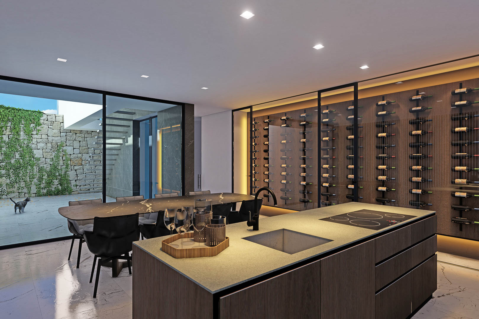 Detalle de la cocina con isla central, vinoteca acristalada y acceso al patio exterior.