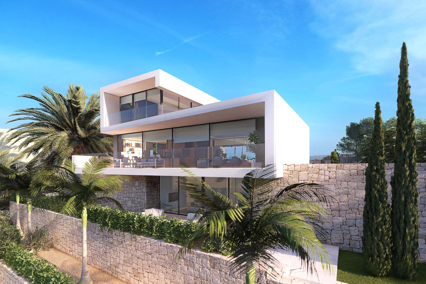 Vista exterior de villa moderna con terrazas, muros de piedra y jardines tropicales bajo un cielo azul despejado.