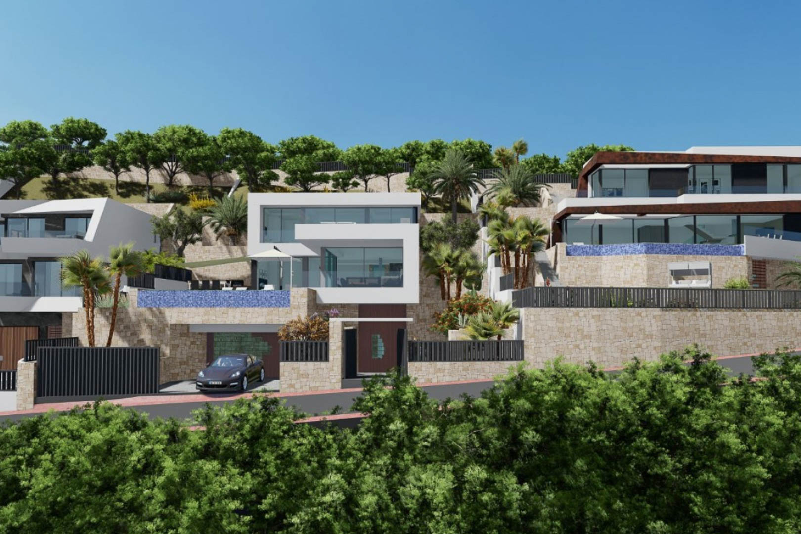 Vista exterior de la villa moderna con arquitectura cúbica, muros de piedra natural, piscina infinity de mosaico azul y jardines integrados en la ladera.