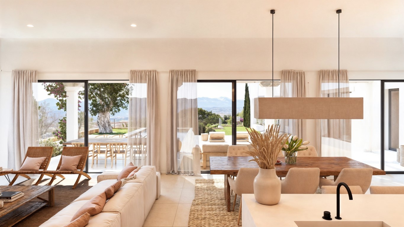 Salón-comedor diáfano con amplios ventanales correderos, mesa de madera maciza y vistas panorámicas al valle y las montañas desde un interior luminoso.