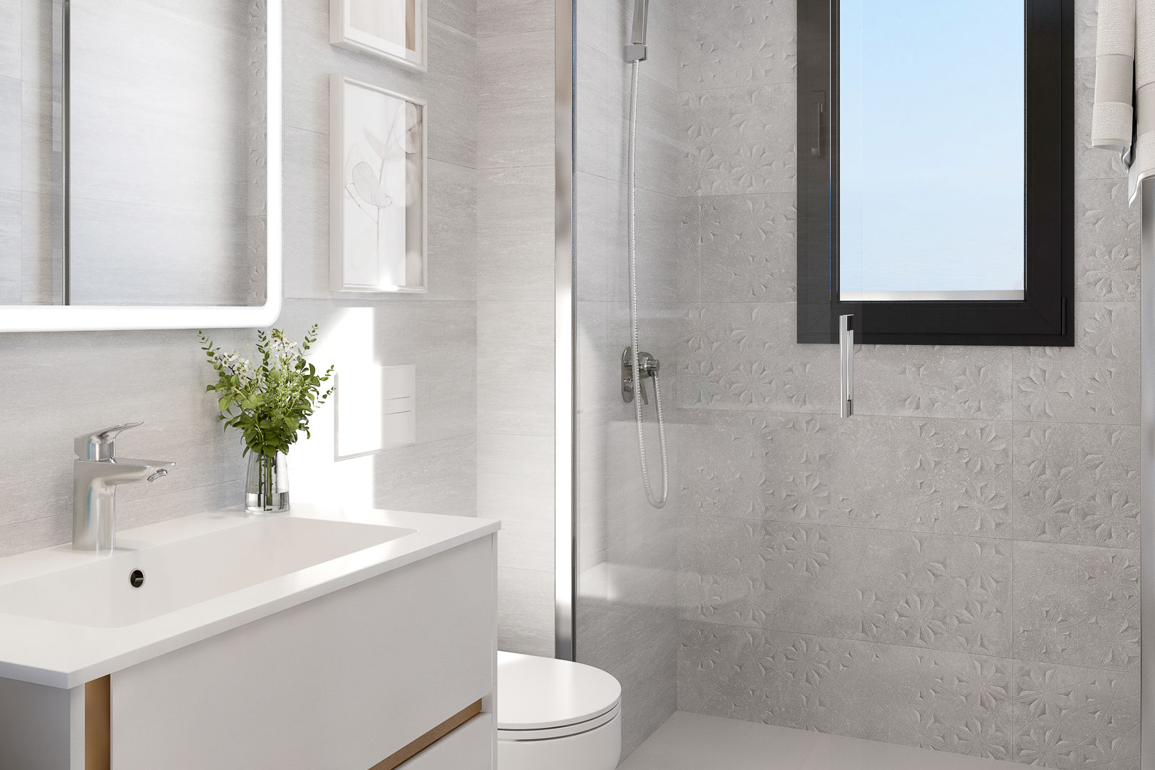 Baño moderno con lavabo integrado, espejo retroiluminado y ducha con mampara de cristal. Destacan los azulejos texturizados en tonos grises y la carpintería exterior en color negro.