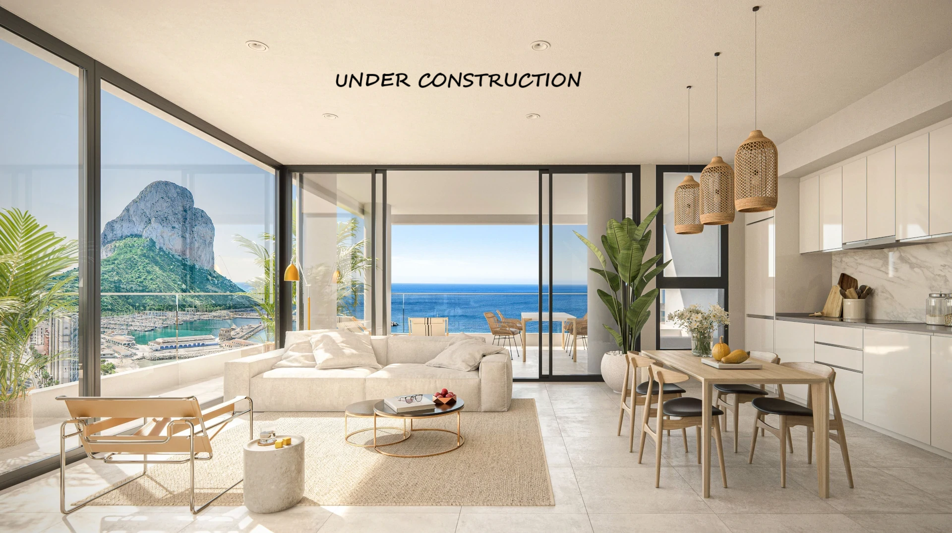 Salón-comedor diáfano con cocina integrada, grandes ventanales y vistas panorámicas al Peñón de Ifach y al mar Mediterráneo desde la terraza privada.