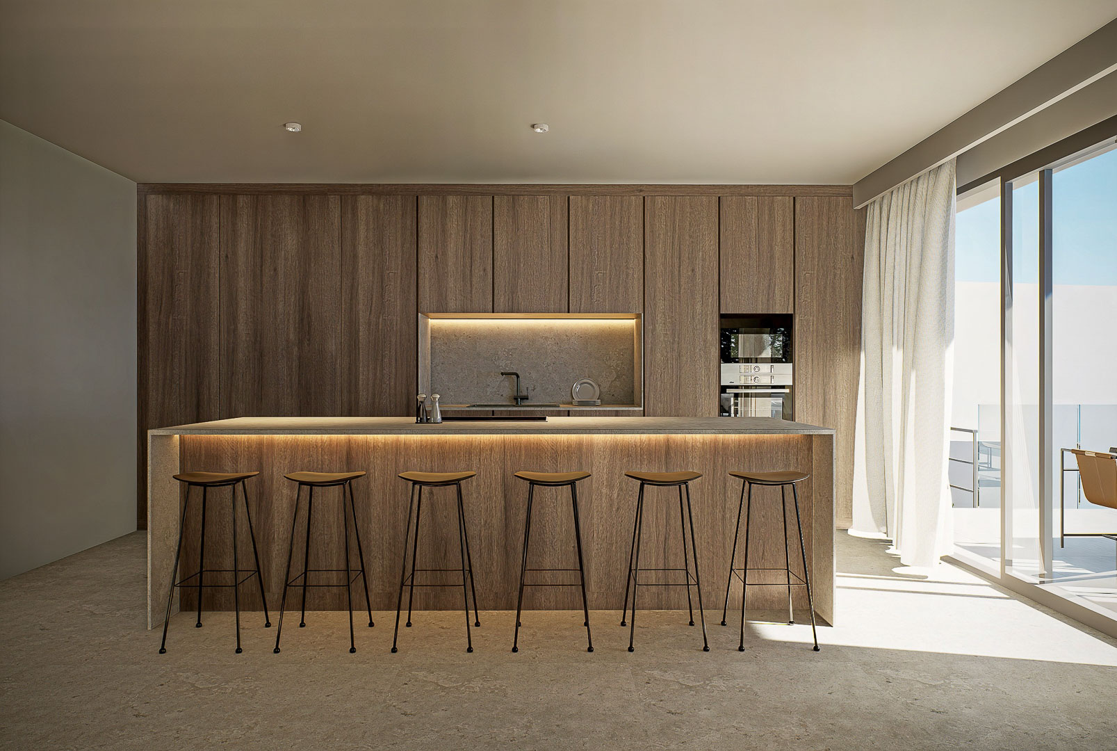 Cocina de diseño con isla central de piedra, taburetes minimalistas y armarios de madera de suelo a techo con iluminación LED integrada y acceso directo a la terraza.