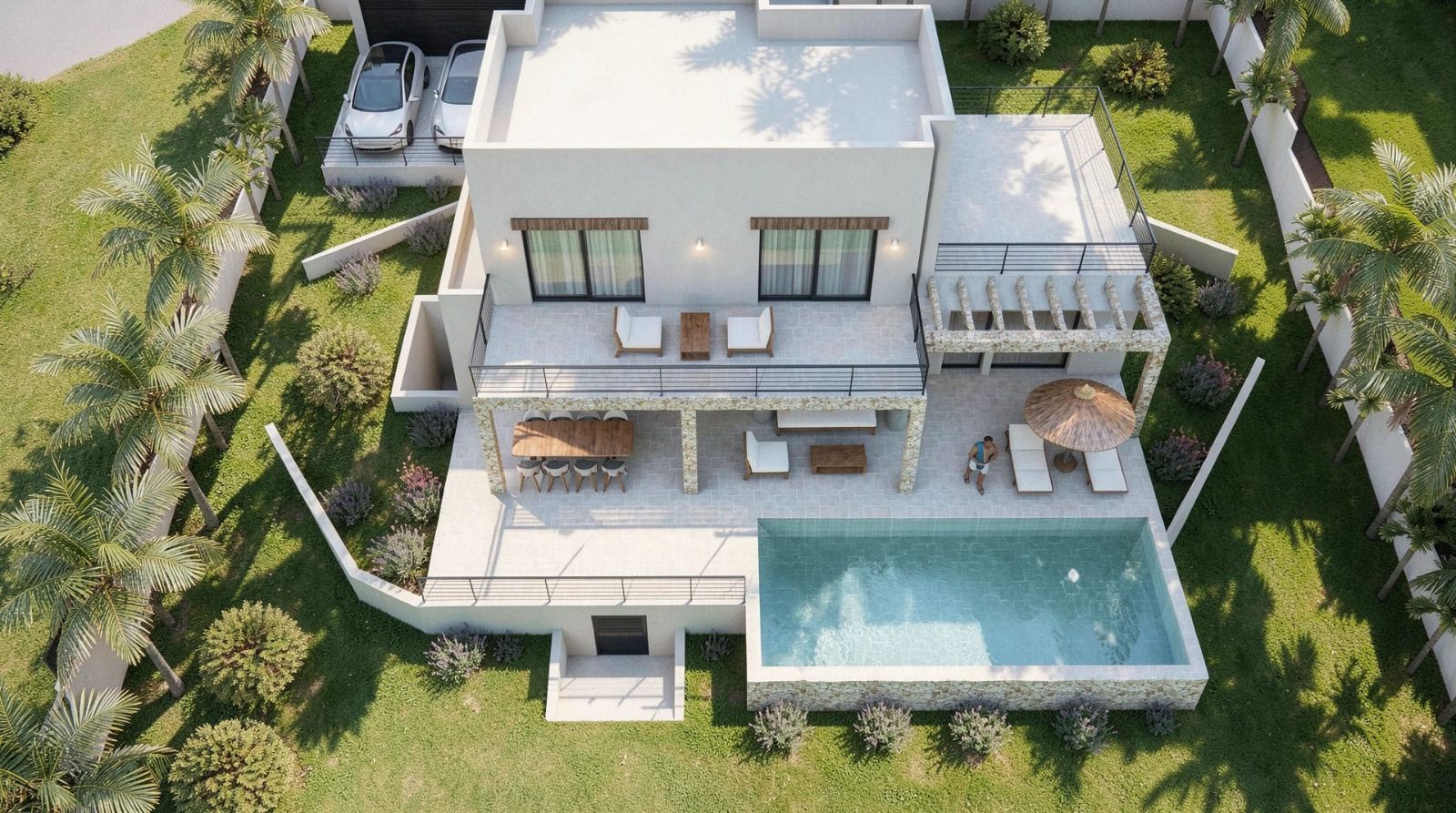 Vista aérea de la villa moderna con piscina rectangular, naya de piedra con comedor exterior, jardín con palmeras y zona de aparcamiento privado.