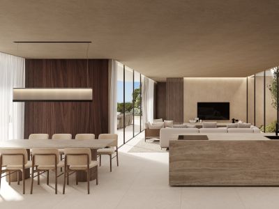 Amplio salón diáfano con comedor y vistas al mar, isla de cocina de piedra y zona de estar con jardín interior, todo conectado por grandes paneles de vidrio.