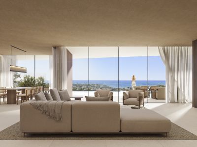 Salón-comedor diáfano con sofá modular, ventanales de suelo a techo y vistas al mar, complementado por un comedor con mesa de madera.
