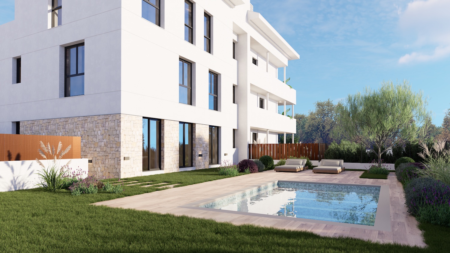 Edificio de apartamentos moderno con fachada blanca y base de piedra. Dispone de un jardín privado con piscina rectangular, pavimento de madera clara y dos tumbonas contemporáneas entre vegetación mediterránea.