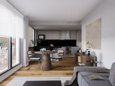 Espacio diáfano que integra una cocina moderna en tonos grises con salpicadero negro, una zona de comedor con mesa de base de espiga de madera y grandes ventanales a una terraza exterior.