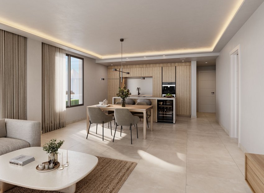 Espacio diáfano moderno con cocina de madera clara, electrodomésticos integrados y vinoteca. Comedor con lámpara lineal y sala de estar con sofá, bajo iluminación natural y luz indirecta en el techo.