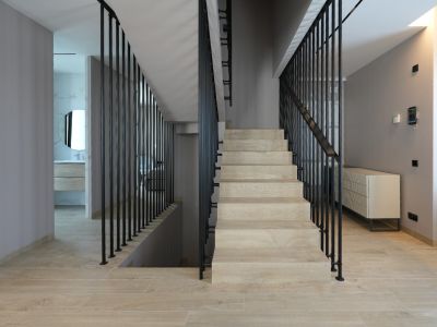Interior moderno con escalera de peldaños en madera clara y barandilla vertical negra. Panel de control domótico en pared, con acceso a baño contemporáneo con espejo redondo.
