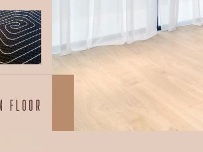 Suelo radiante visible en detalle, complementado con elegante tarima de madera clara y cortinas blancas.