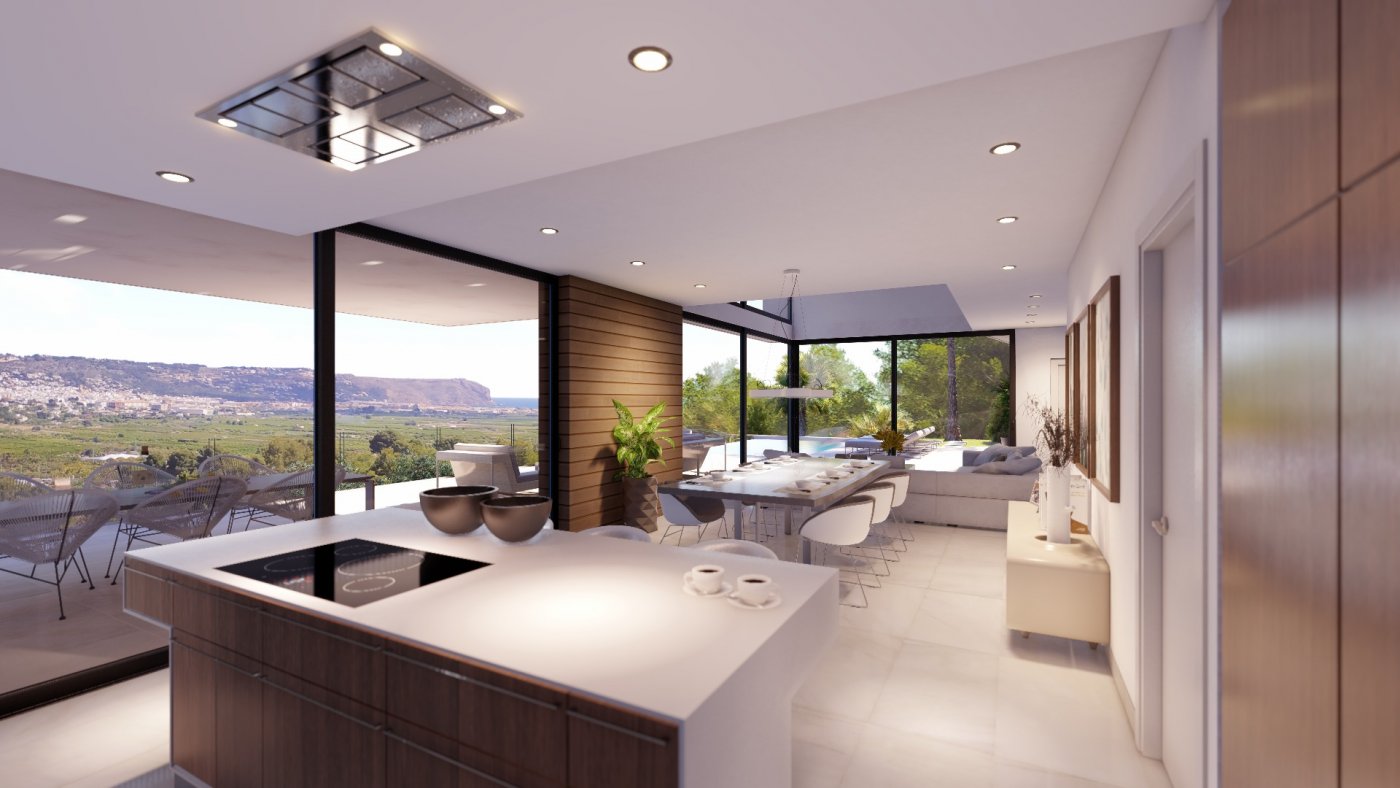 Zona de estar diáfana con isla de cocina, comedor y grandes ventanales correderos que ofrecen vistas despejadas al valle, la costa y la terraza exterior.