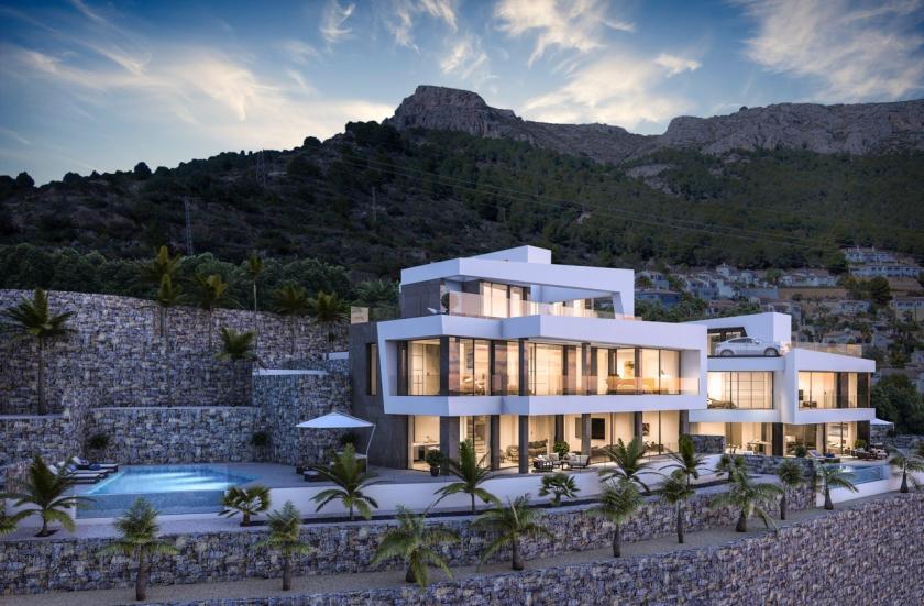 Vista exterior de la villa con piscina infinita y fachada de piedra natural. Vista exterior de la villa con piscina infinita y fachada de piedra natural.