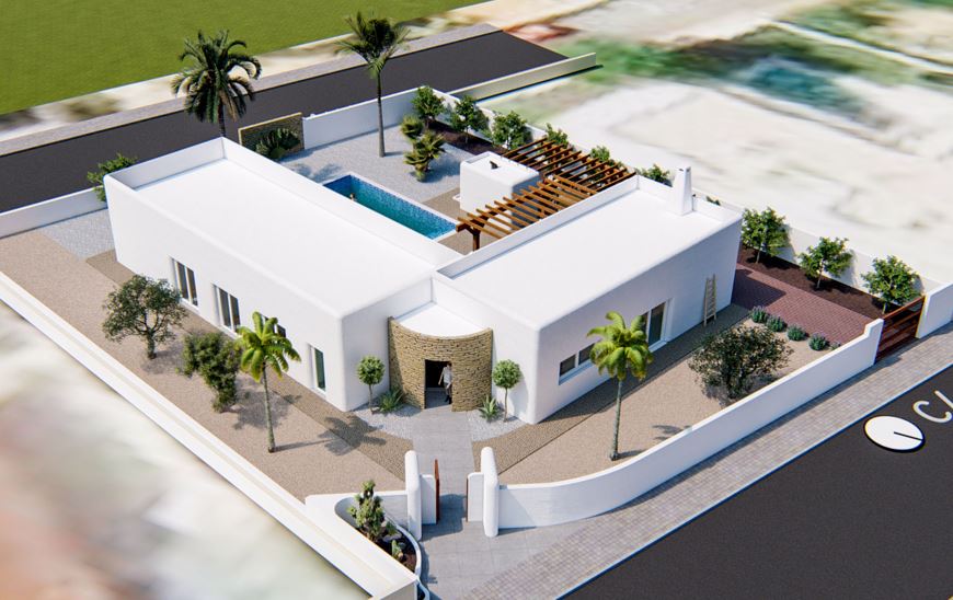 Vista aérea de la villa de estilo ibicenco con fachada blanca, piscina central y pérgola de madera. Destaca la entrada con muro de piedra y el jardín mediterráneo perimetral.