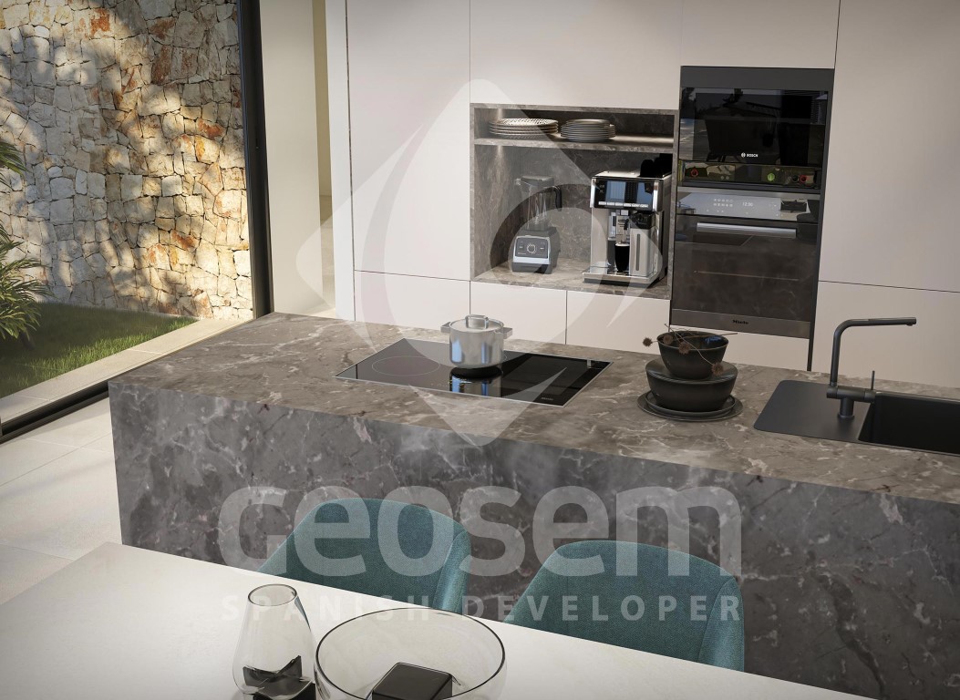 Cocina de diseño con isla de piedra gris veteada, placa de inducción integrada y electrodomésticos de alta gama empotrados en armarios minimalistas blancos.