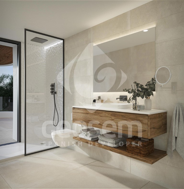 Cuarto de baño contemporáneo con mueble de madera suspendido, espejo retroiluminado y ducha de obra con perfilería negra y azulejos en tonos neutros.