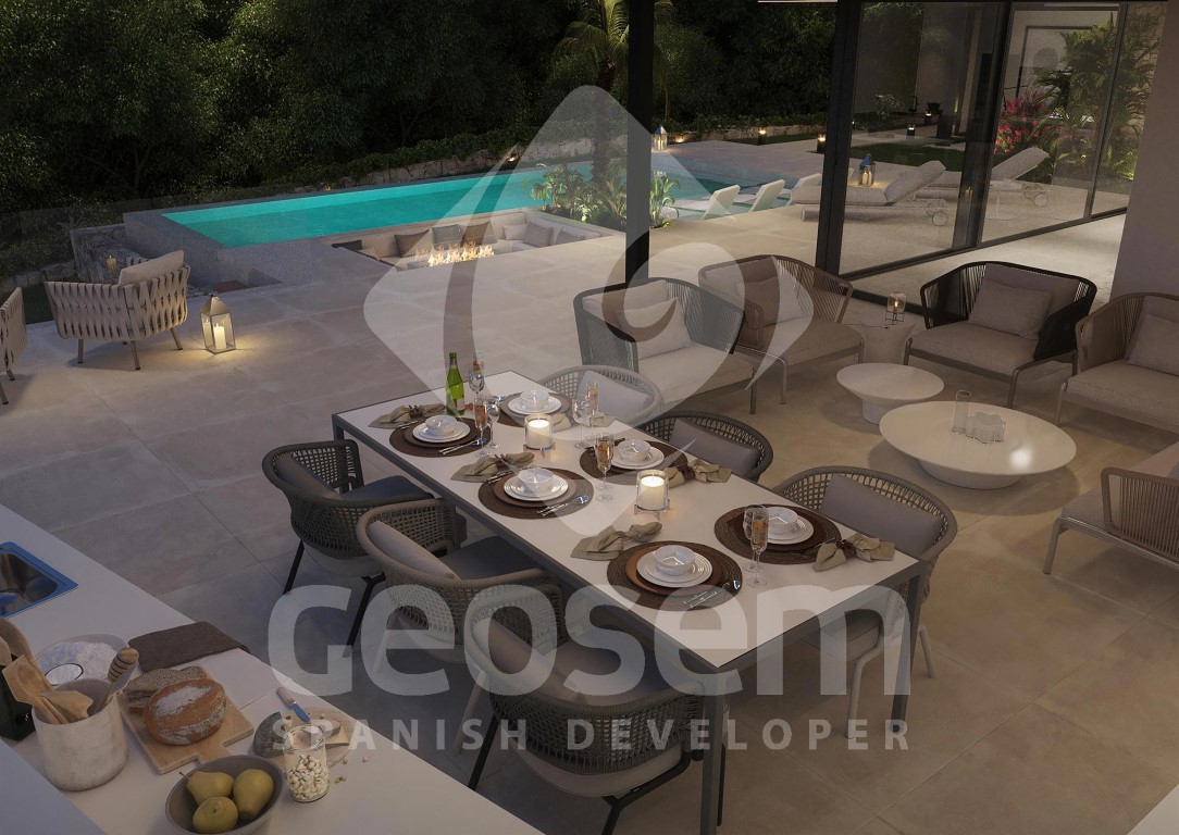 Terraza exterior con zona de comedor, salón al aire libre y cocina de verano junto a una piscina infinita con foso de fuego integrado.