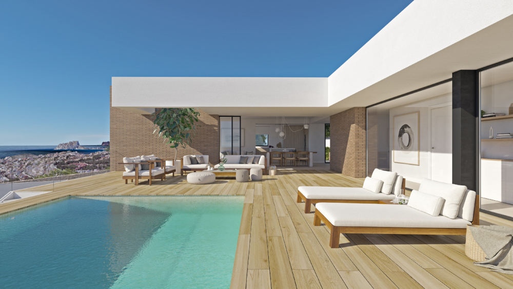 Terraza principal con tarima de madera, piscina infinita y mobiliario de exterior frente a vistas panorámicas del Mediterráneo y el Peñón de Ifach.