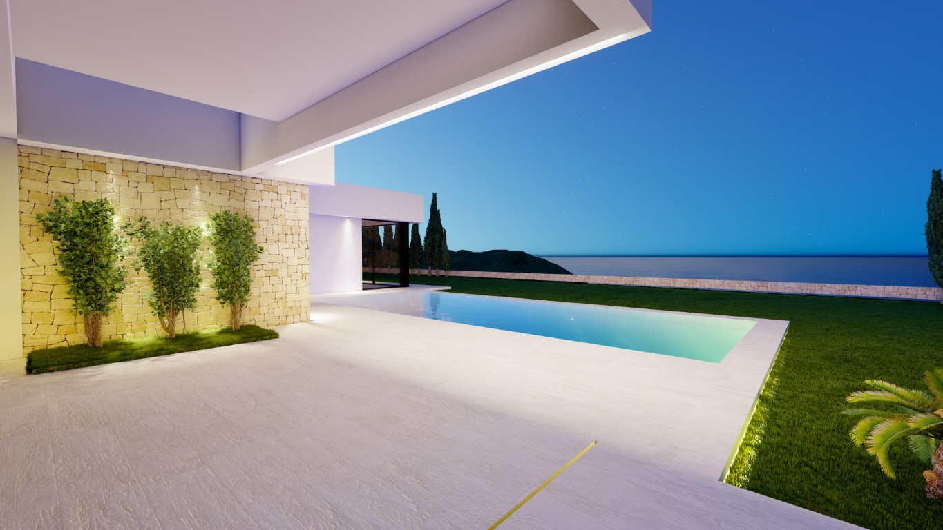 Terraza exterior con piscina rectangular iluminada, muro de piedra natural decorativo y vistas despejadas al mar bajo un cielo estrellado.