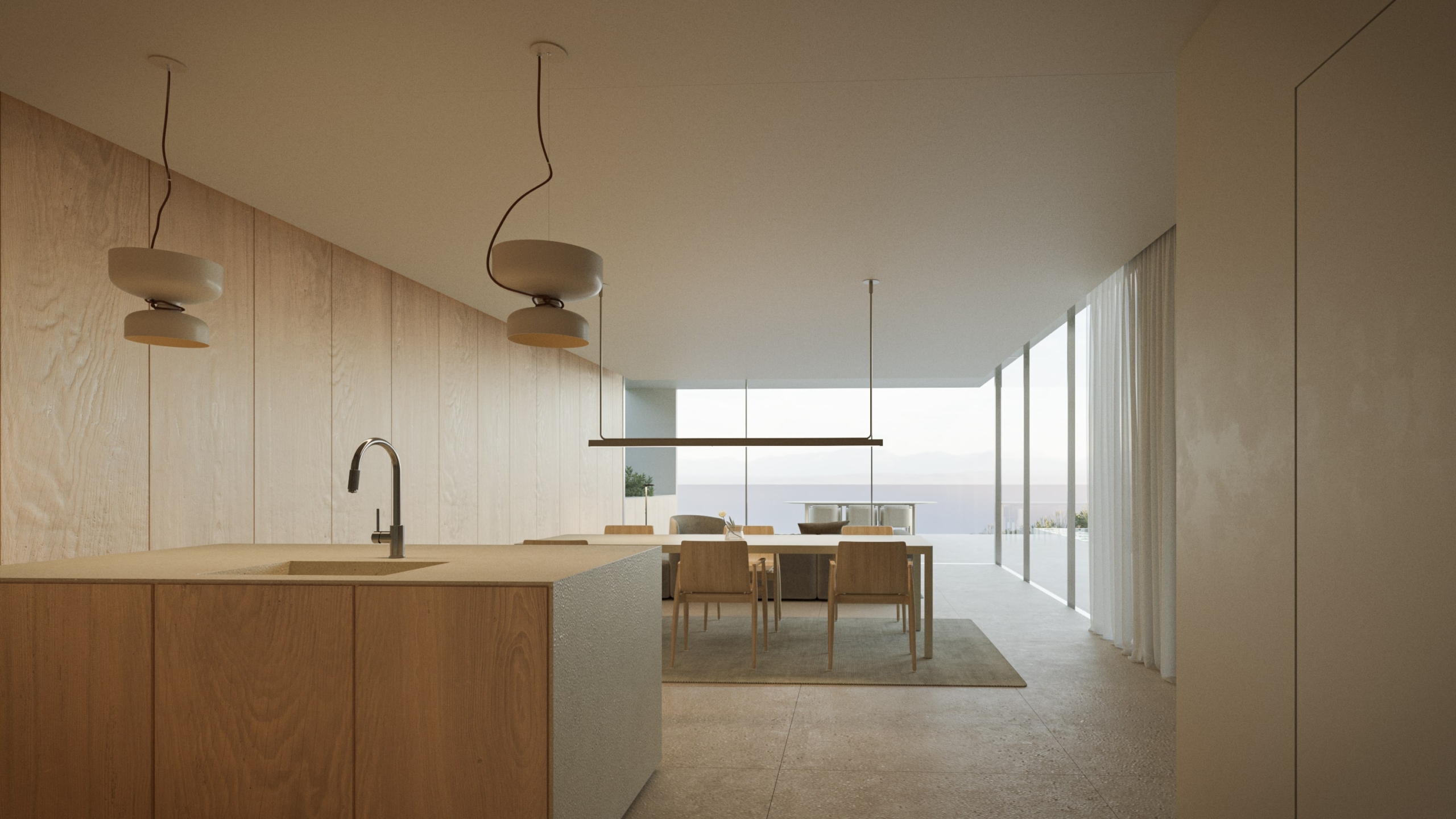 Cocina de diseño con isla de madera, panelado de pared a juego y comedor integrado frente a grandes ventanales con vistas al mar.