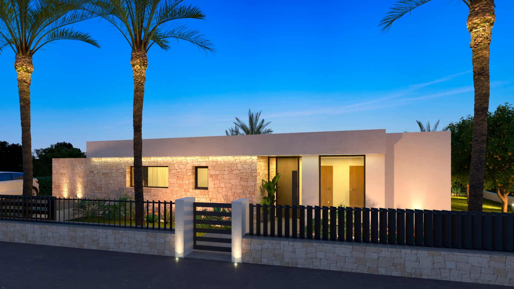 Fachada iluminada de la villa, con revestimiento de piedra natural y puerta de entrada de madera.