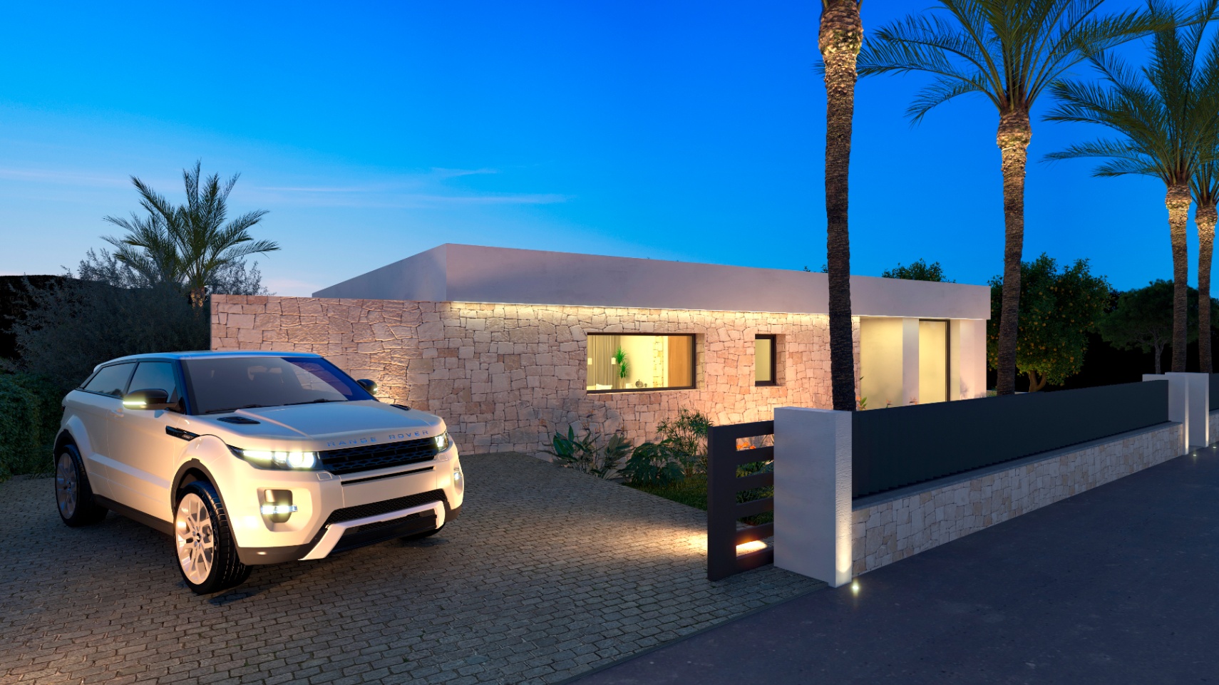Vista exterior de la villa con fachada de piedra iluminada y Range Rover en el camino de entrada.