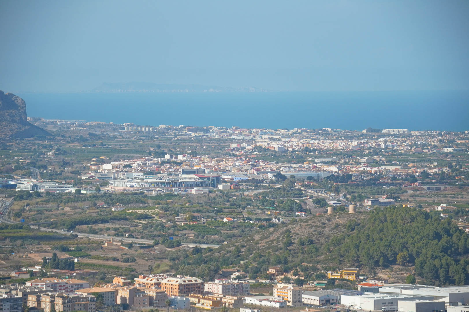 Vistas panorámicas desde la propiedad hacia el valle, núcleos urbanos y el mar Mediterráneo en el horizonte bajo un cielo despejado.