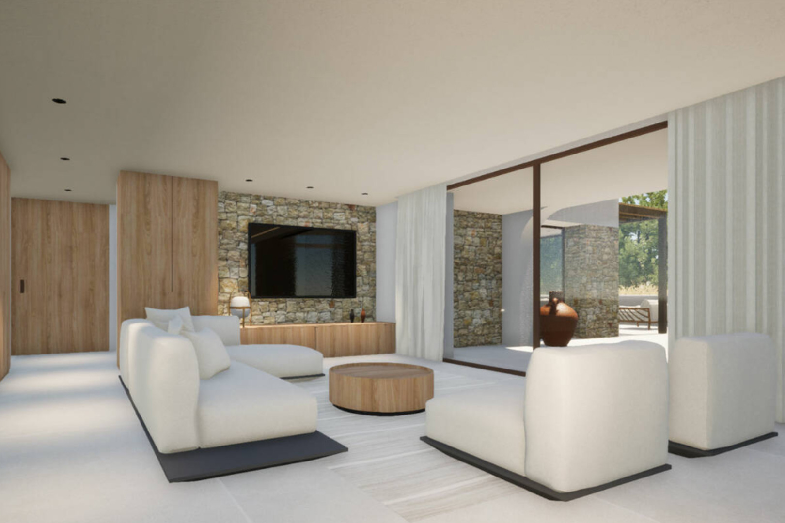 Salón con pared de piedra, sofá modular blanco y mesa de centro redonda de madera.