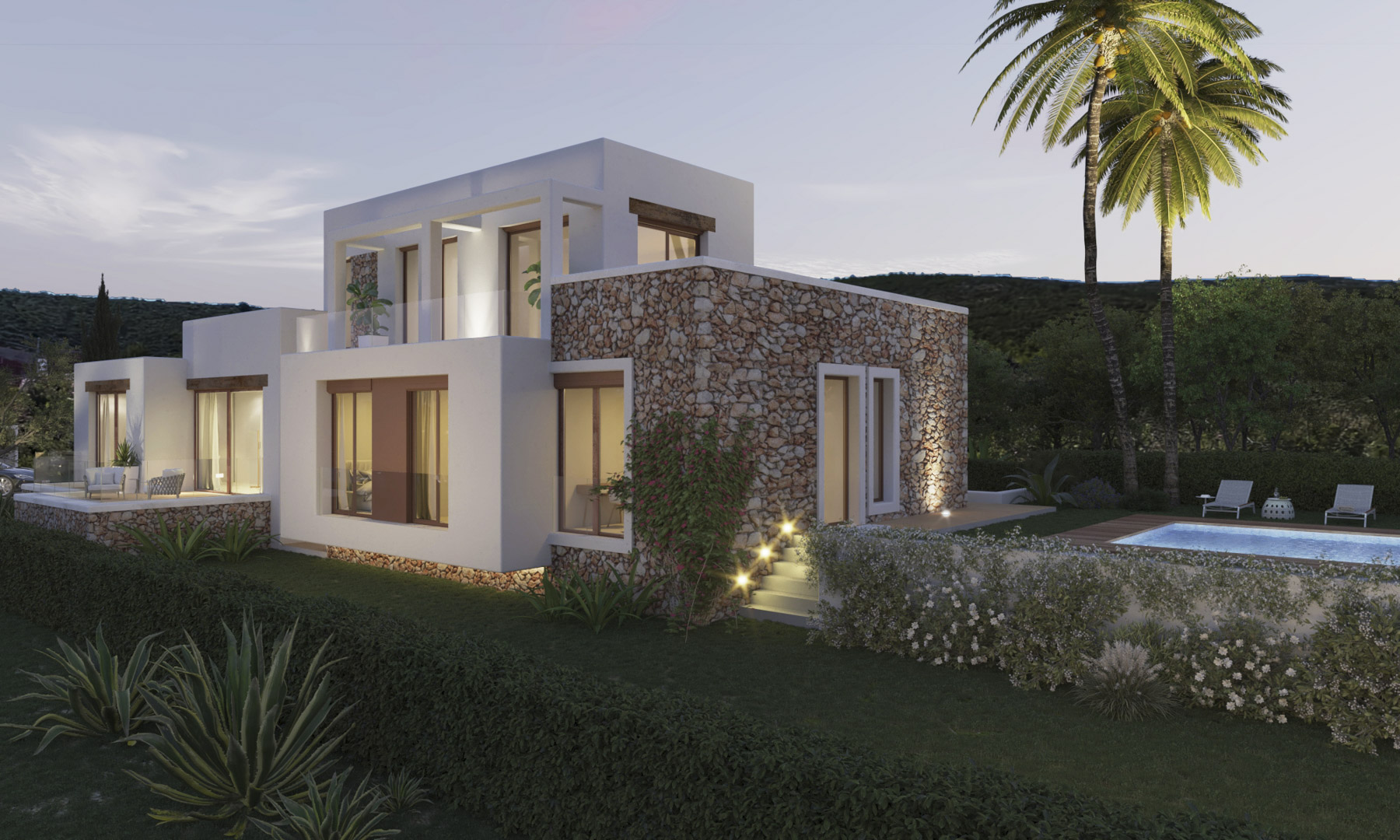 Fachada exterior de estilo ibicenco que combina muros de piedra natural con acabados en blanco, integrando amplios ventanales, terrazas con cristal y una piscina iluminada.