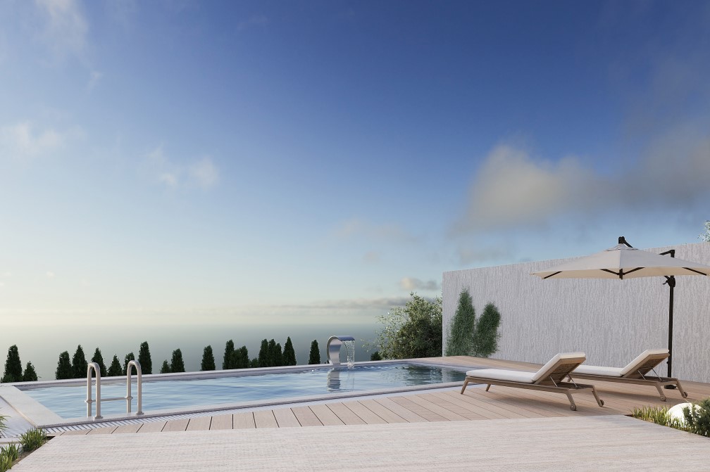 Vista de la piscina privada con cascada y tumbonas, rodeada de vegetación y con vistas al mar.