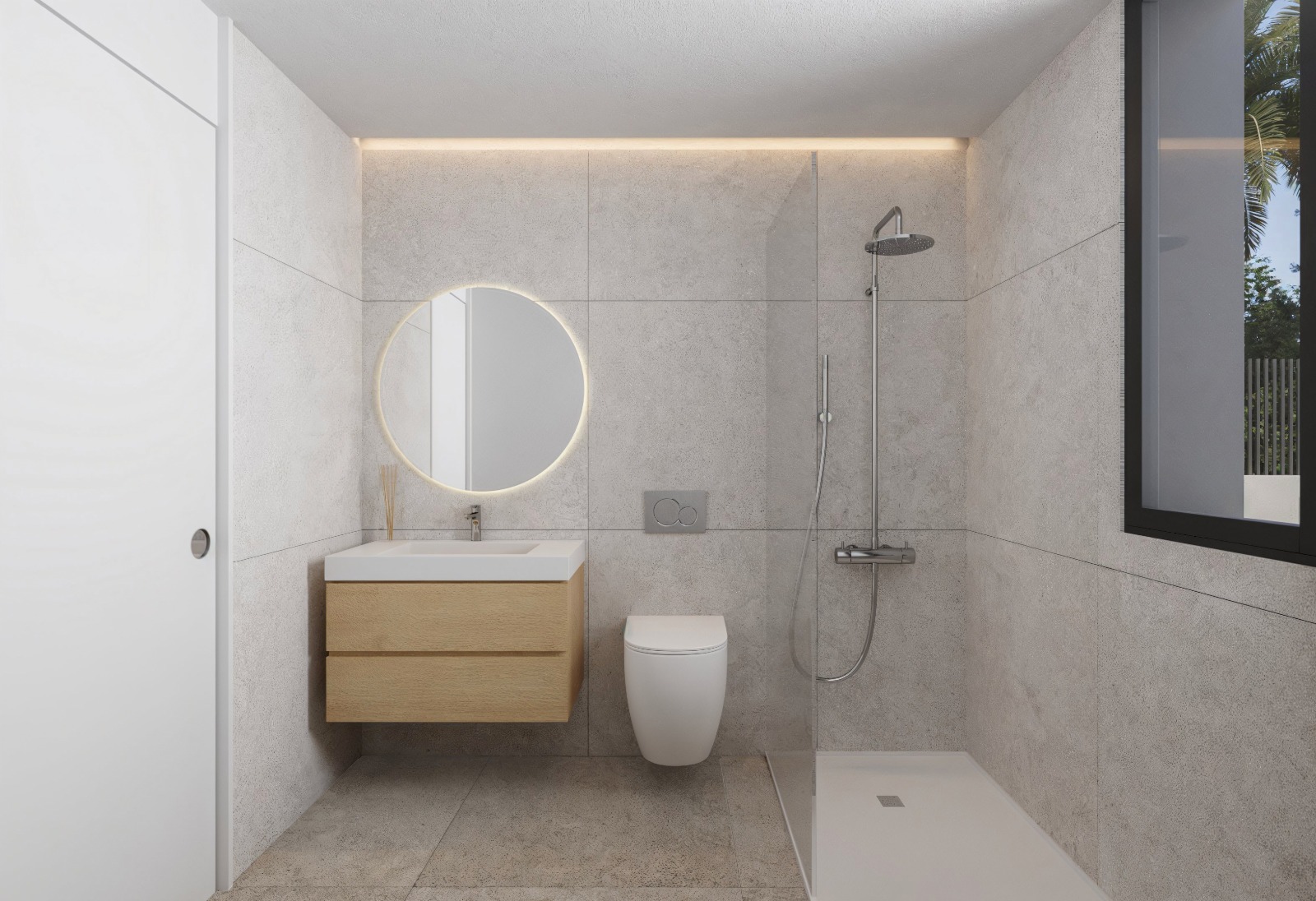 Baño moderno con azulejos de gran formato en tonos grises, mueble de lavabo de madera clara, espejo circular retroiluminado y ducha italiana con mampara de cristal.