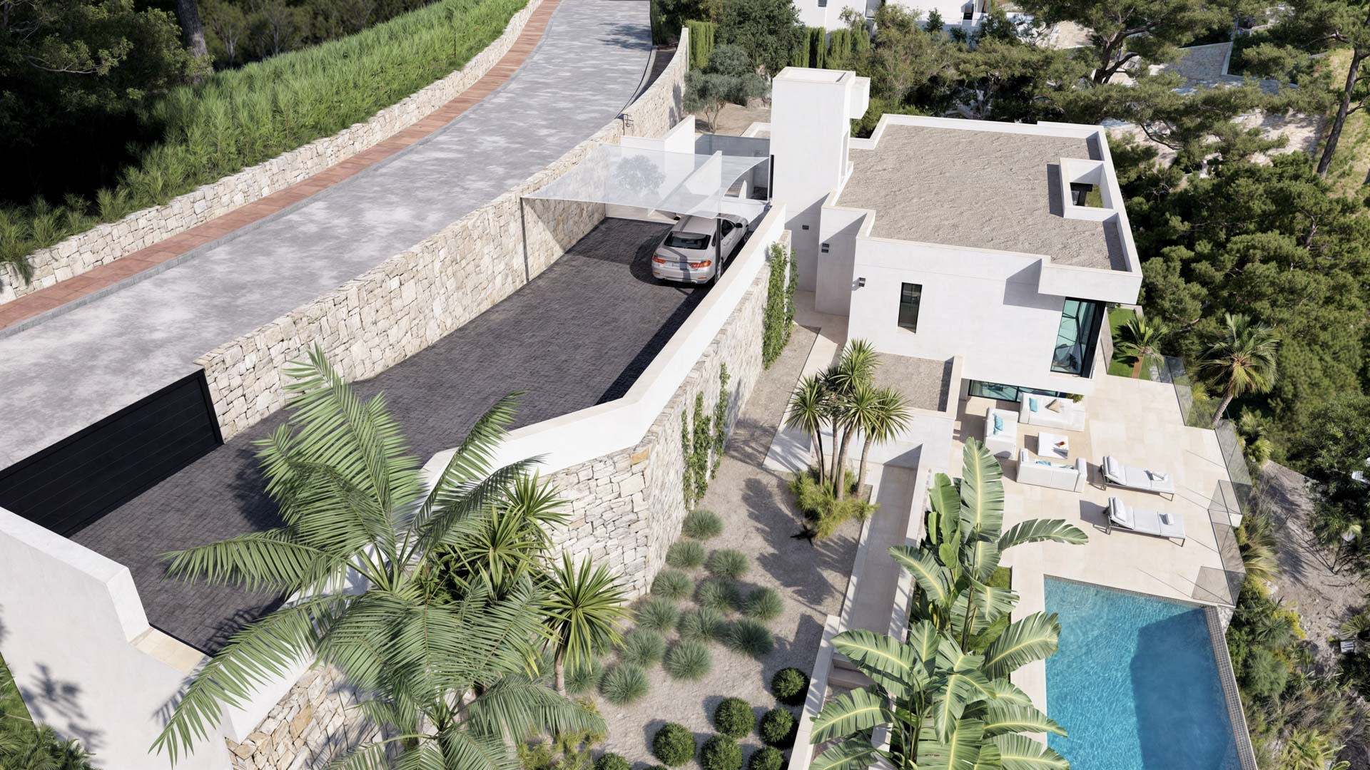 Vista aérea del acceso principal con muros de piedra seca, zona de aparcamiento sombreada y la transición hacia la terraza con piscina y jardines mediterráneos.