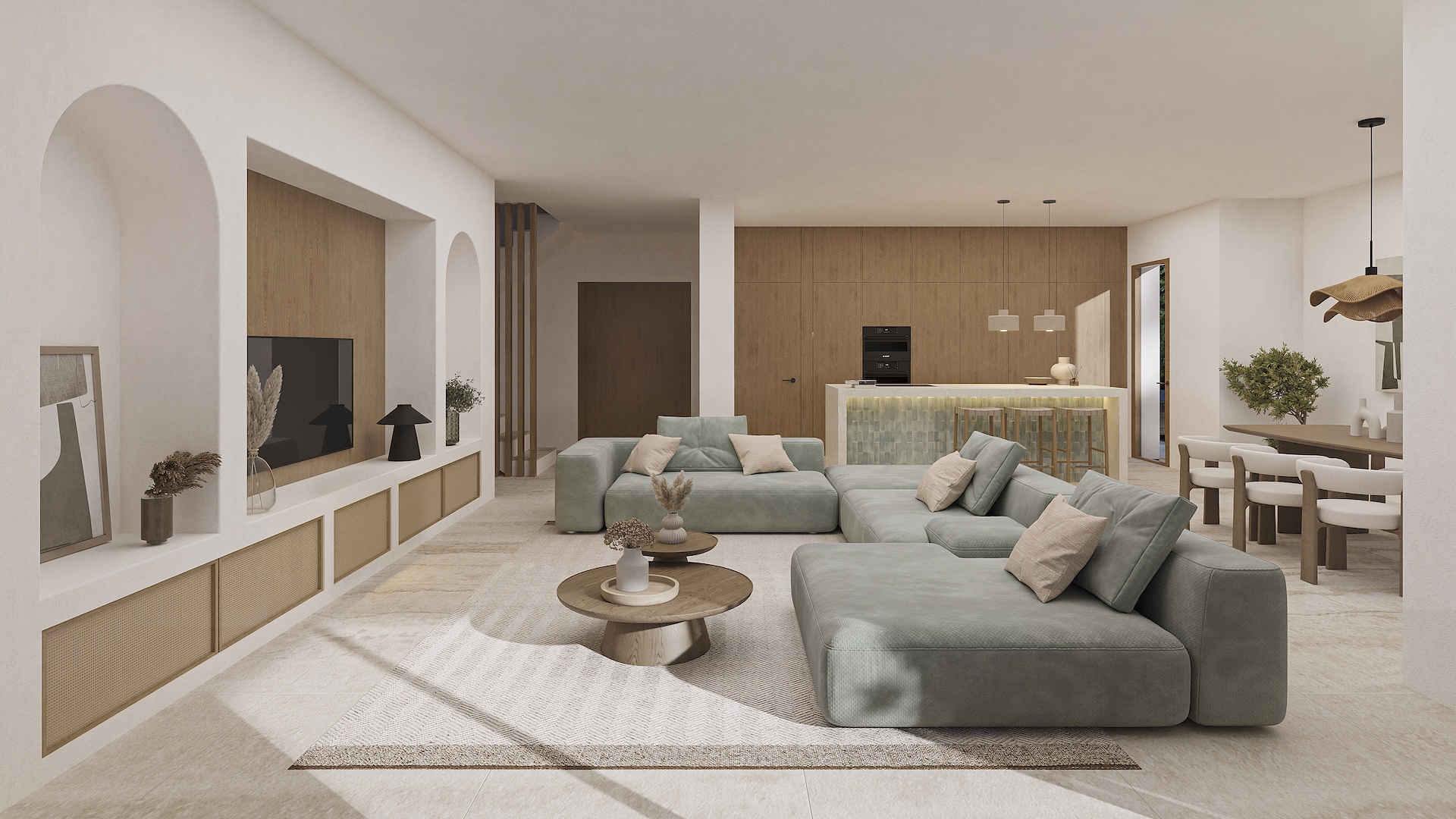 Salón diáfano con sofás modulares, hornacinas arqueadas integradas y una transición fluida hacia la cocina de diseño y el comedor de estilo ibicenco.