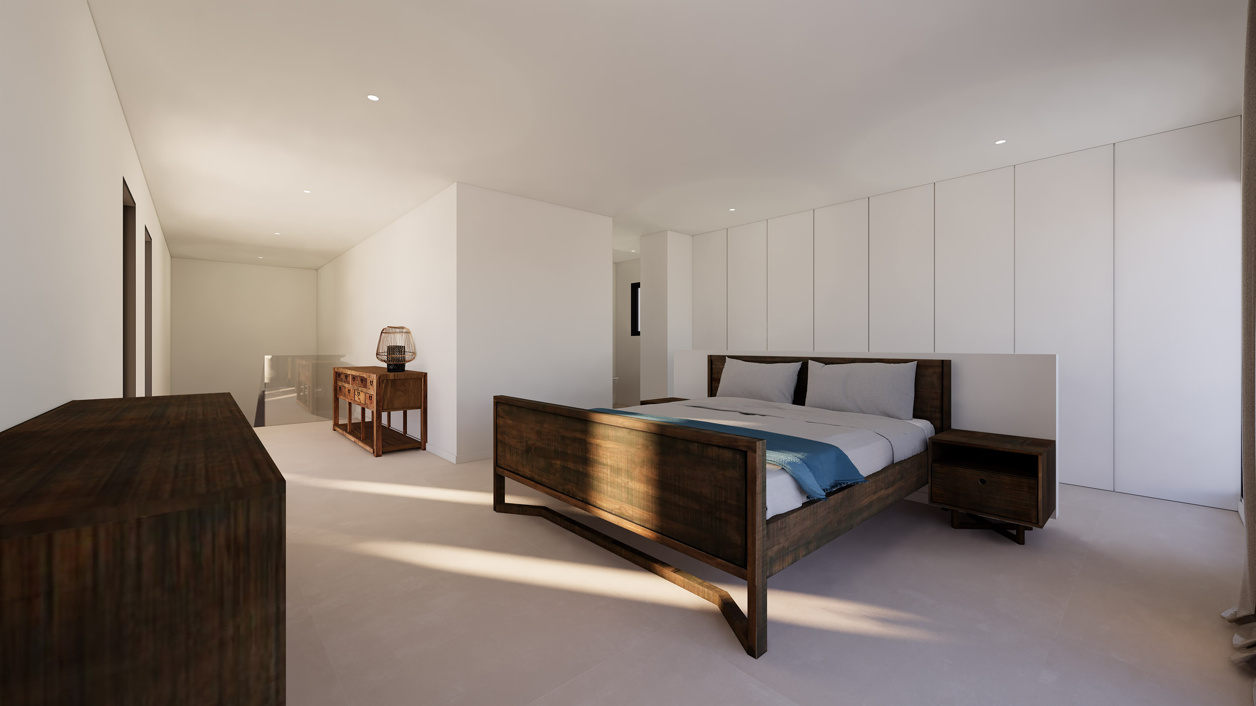 Dormitorio con mobiliario de madera oscura, armarios empotrados blancos y zona de paso hacia la escalera con barandilla de cristal y luz natural.