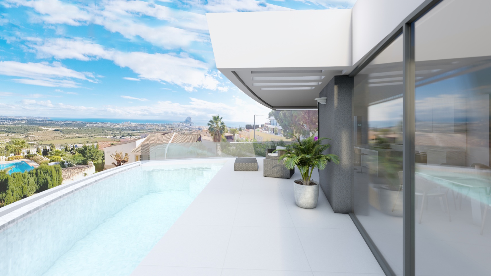 Terraza con piscina infinita, barandillas de cristal y vistas panorámicas al Peñón de Ifach. El suelo de gres blanco se integra con el interior mediante grandes ventanales.