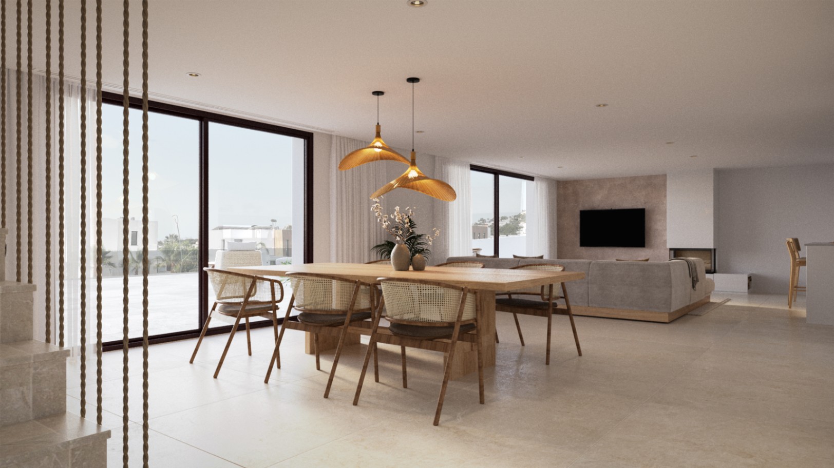 Salón-comedor diáfano con mesa de madera maciza, sillas de ratán y lámparas de diseño orgánico. Grandes ventanales conectan el espacio interior con la terraza exterior.