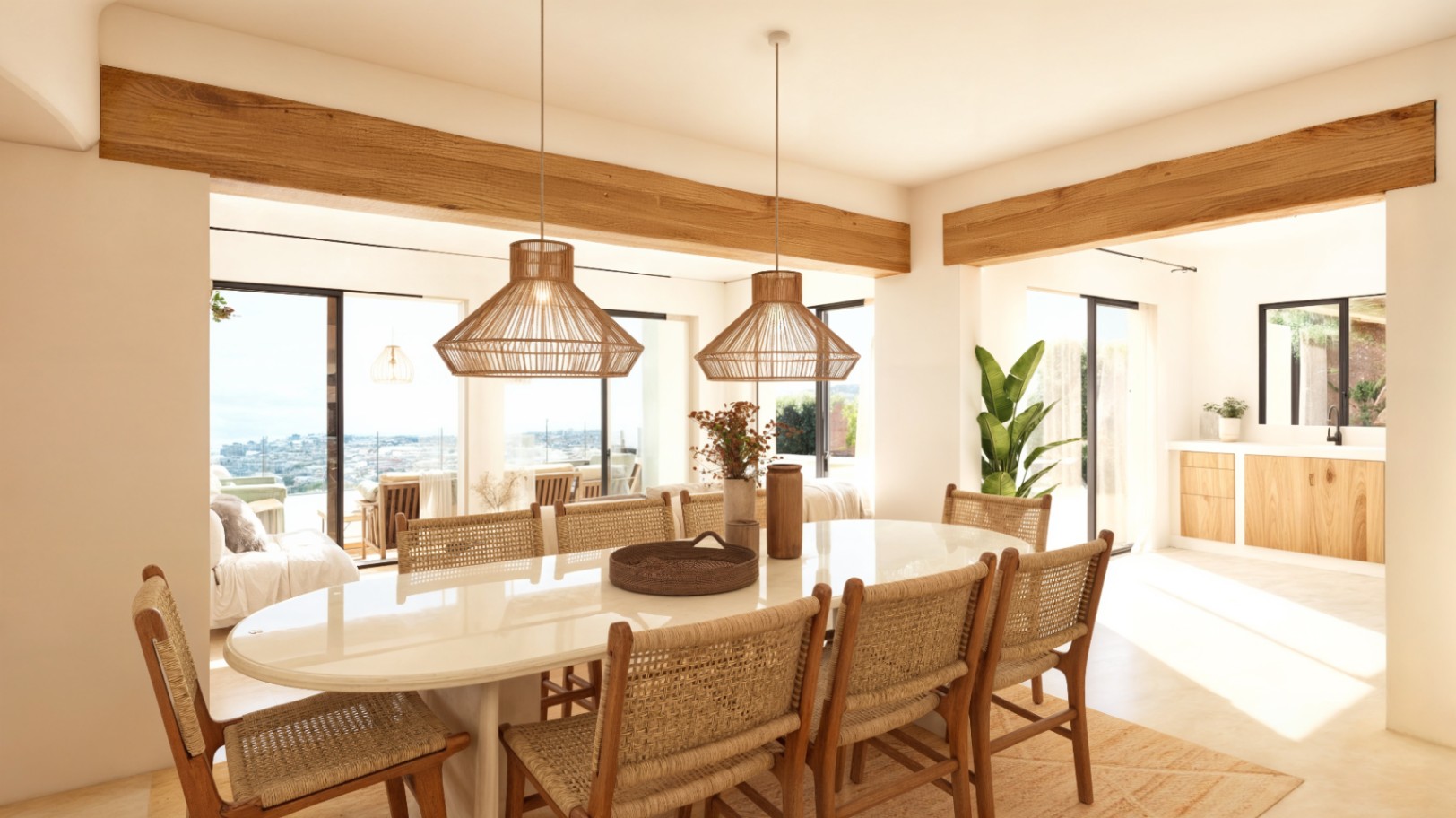 Comedor de estilo ibicenco con mesa ovalada, sillas de fibras naturales y vigas de madera vistas, conectado a la terraza con vistas al mar mediante ventanales Technal.