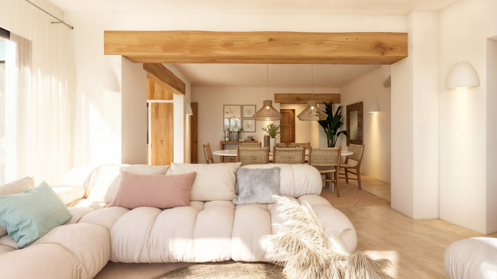 Salón-comedor diáfano con vigas de madera natural, mobiliario de estilo mediterráneo y una iluminación cálida integrada en paredes blancas de estilo ibicenco.