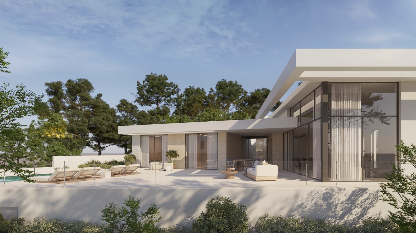 Exterior de villa moderna con amplia terraza de gres porcelánico, zona de estar exterior y ventanales de suelo a techo integrados en una fachada blanca con detalles de piedra natural.