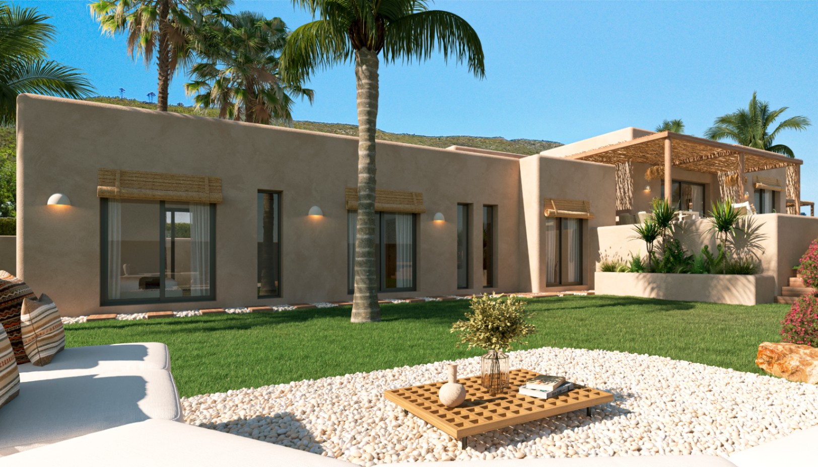 Fachada mediterránea en tonos tierra con ventanales de carpintería oscura, persianas de fibra natural y un jardín con césped, palmeras y zona de descanso sobre grava blanca.