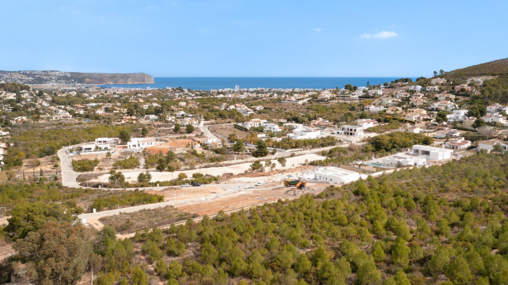 Vista aérea de Lomas Del Rey en Jávea, destacando la proximidad al mar y la integración de las parcelas residenciales en un entorno natural privilegiado.