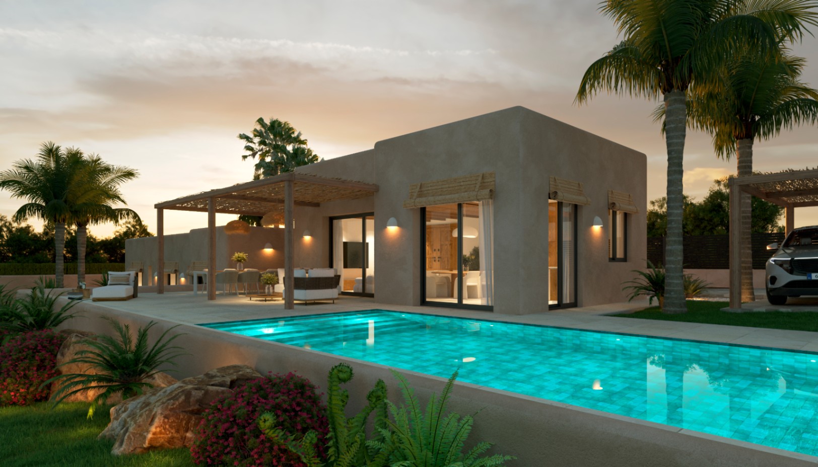 Vista exterior de la villa con piscina iluminada, fachada en tonos tierra y terrazas equipadas con pérgolas de madera y cañizo bajo la luz del atardecer.