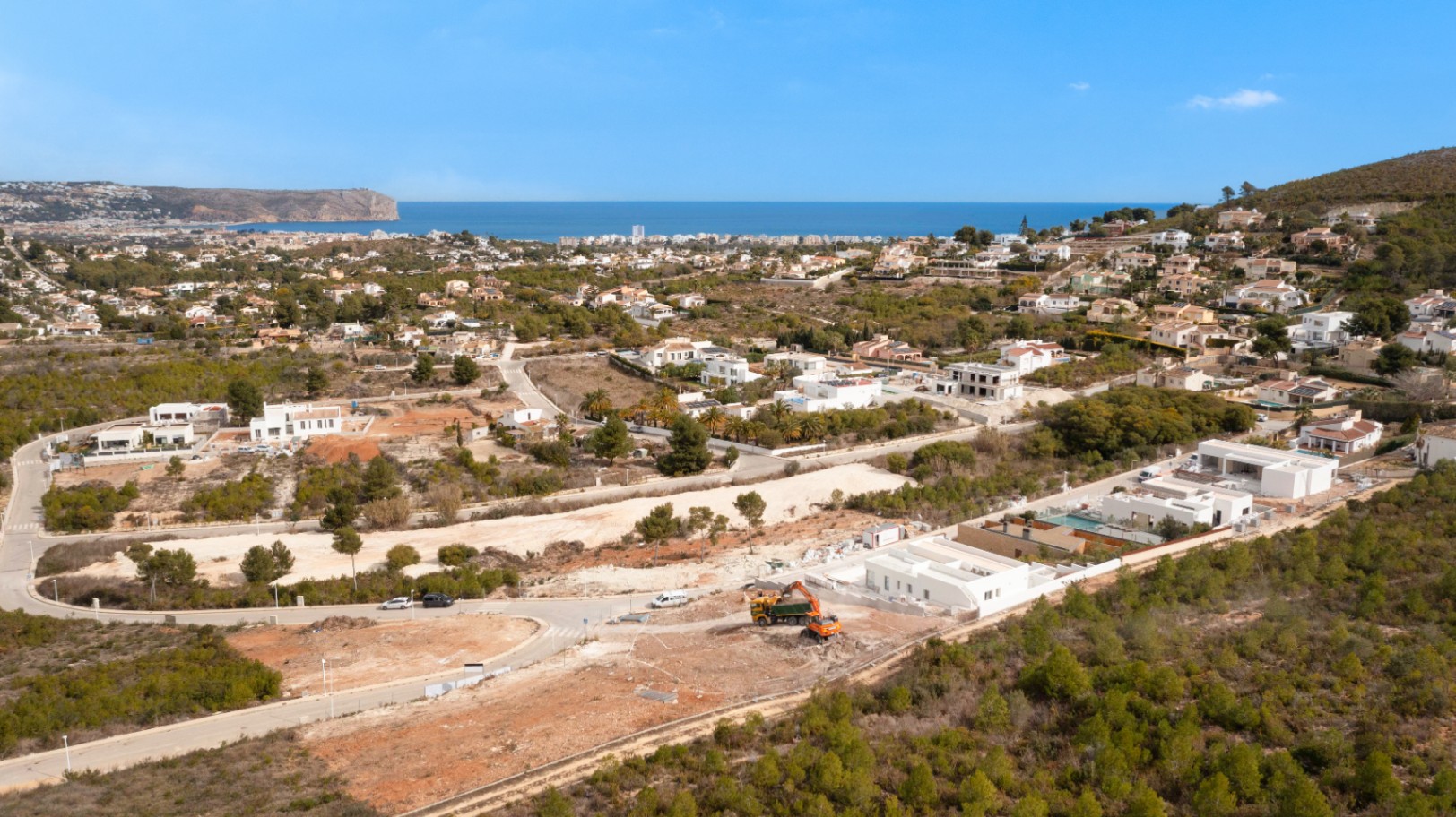 Vista aérea de la parcela en Lomas Del Rey, Jávea, mostrando la proximidad al mar Mediterráneo y el entorno natural rodeado de pinos y villas modernas.